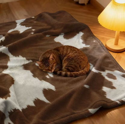 Cowhide print flannel pet blanket.