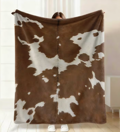 Cowhide print flannel pet blanket.
